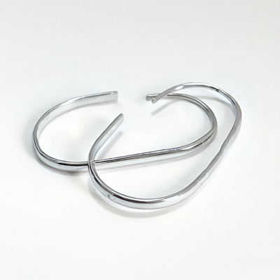 U-shaped open hoop earrings made with Sterling Silver plating, featuring a modern, minimalist, and open curved design, displayed on a white background. These unique earrings are available in Ottawa, Ontario, Canada