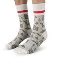 Gray socks with nature-themed design and red stripes on a white background