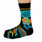 A pair of black socks with a laundry-themed design. The socks feature a washing machine, detergent bottles, a laundry basket, and socks themselves. It reads 