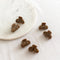 Six small, leopard print hair claw clips arranged on a white marble surface. The clips have a marbled texture.