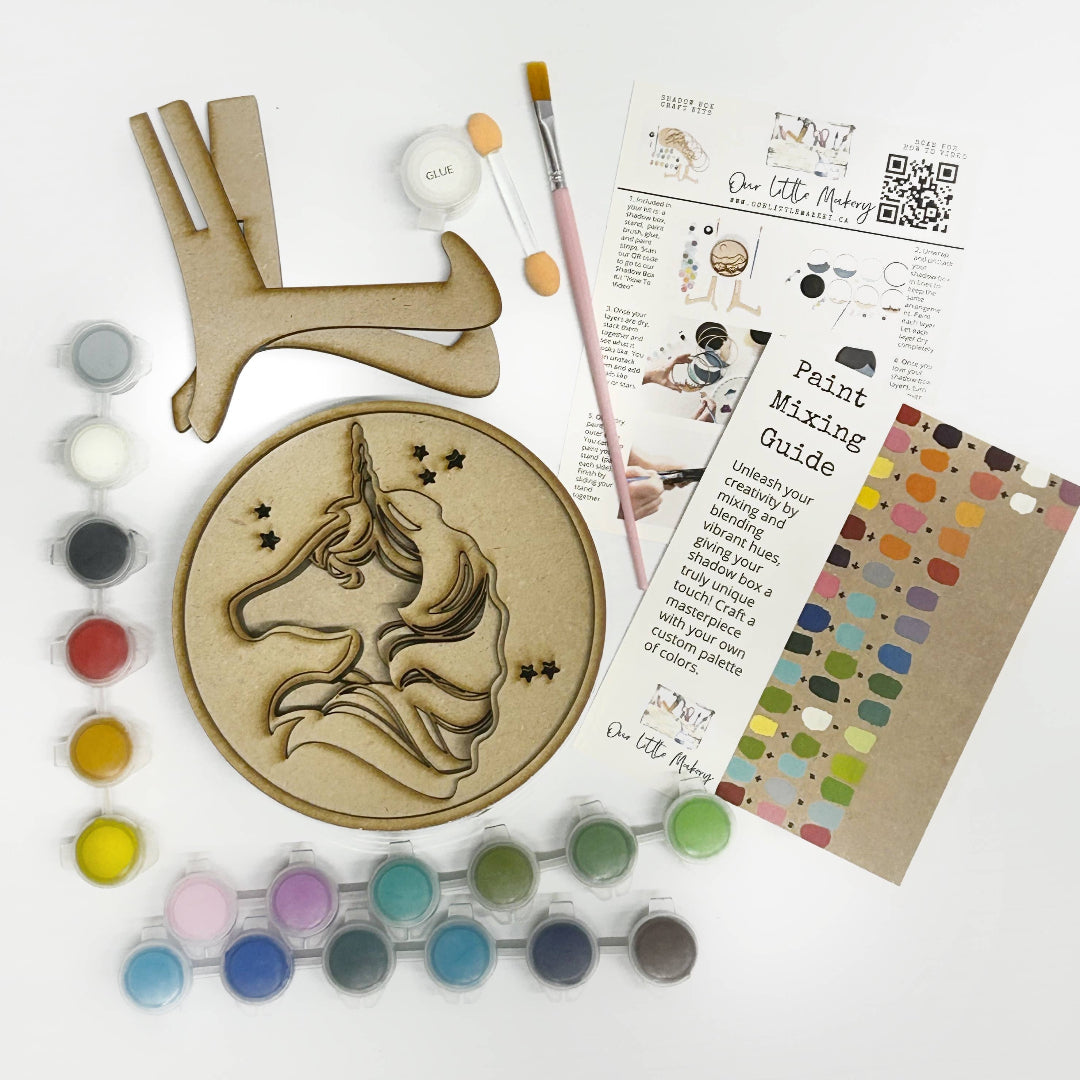 Crafting kit with wooden unicorn design, paint, and mixing guide on a white background