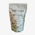 A stand-up pouch of pickle and myrh Vanilla Bean Caramels on a plain white background.