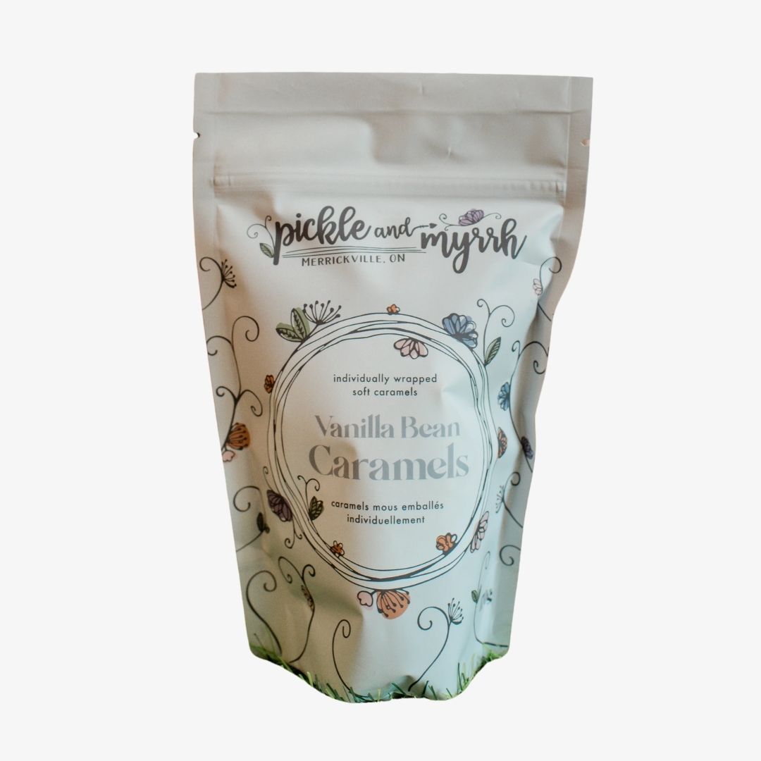 A stand-up pouch of pickle and myrh Vanilla Bean Caramels on a plain white background.