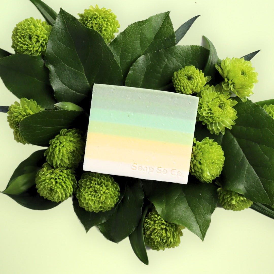 Green flowers with a square card featuring a gradient design and 'Soda So Co' text.