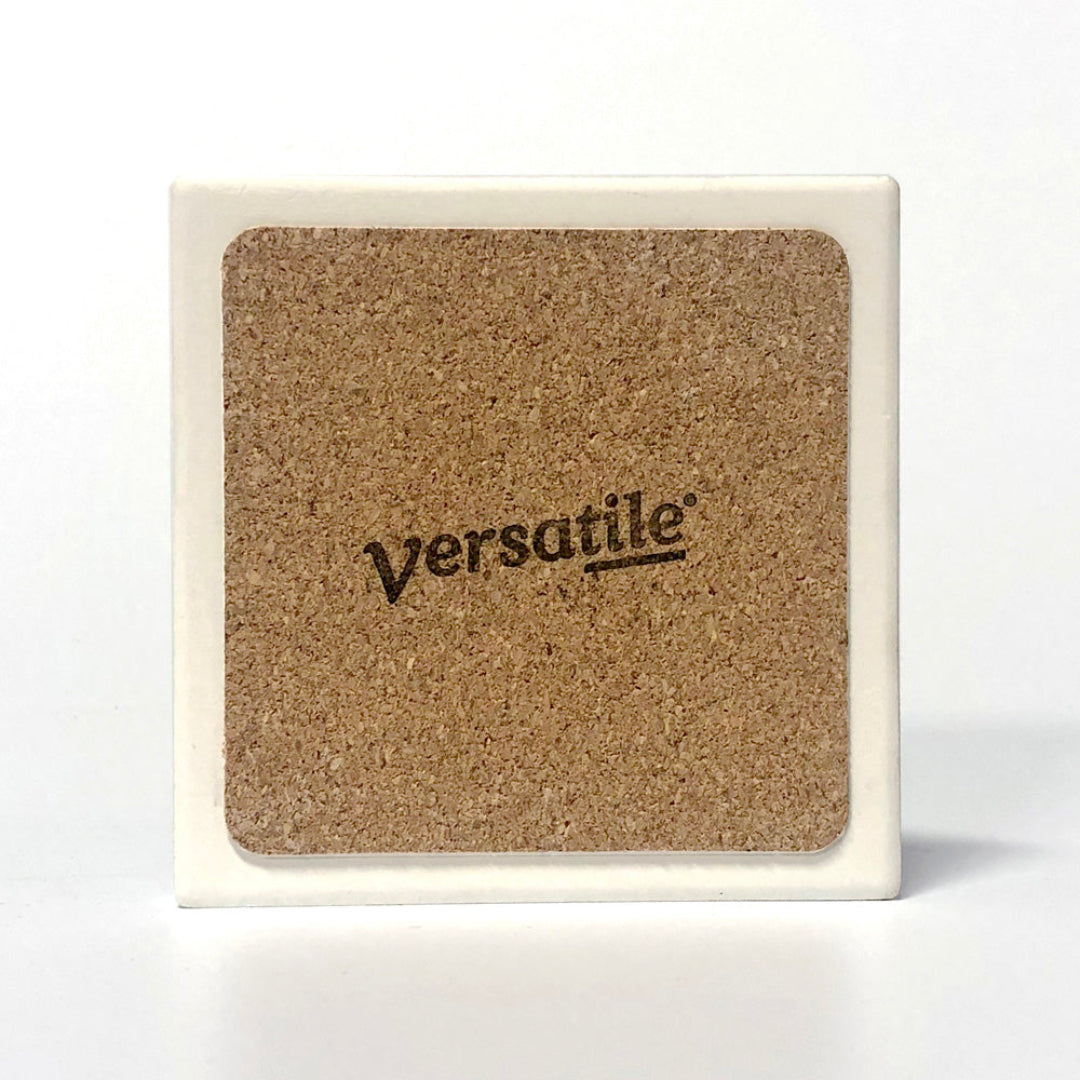 Cork coaster with 'Versatile' branding on a white background