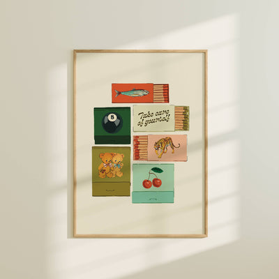 Framed artwork with colorful matchbox designs on a white wall