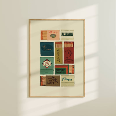 Framed poster with vintage matchbox labels on a white wall