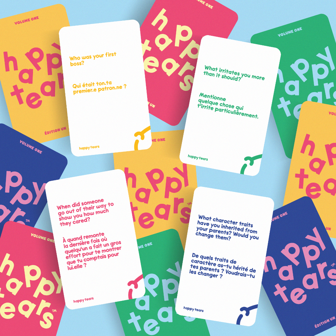 Happy Tears conversation cards, Ottawa. Inclusive card game for meaningful connections. Grey drawstring bag, multicoloured rainbow cards. Fun queer card game.
