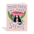 Greeting card with two skunks holding a flower and text 'Together we make scents' on a pink background.