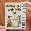 Plantable card with a baby animal illustration and QR code on a brown background