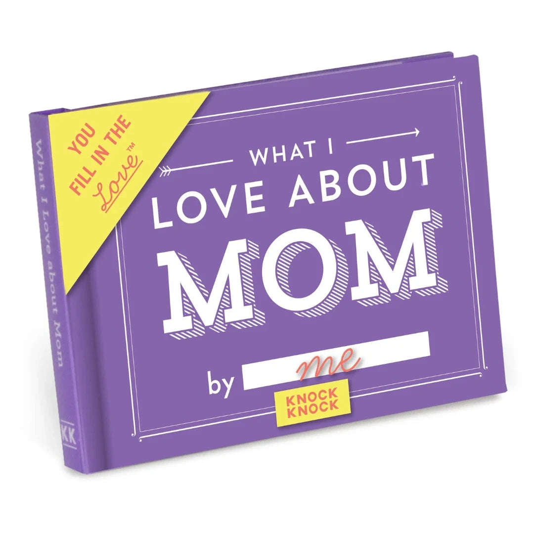 A purple book titled "What I Love About Mom" by Knock Knock. The book has a gold sticker on the front that says "YOU FILL IN THE LOVE." The cover also features the phrase "What I Love About Mom" in large, bold letters.