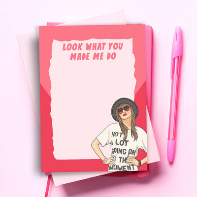 A humorous notepad featuring a cartoon of Taylor Swift with her hands on her hips, wearing a hat and sunglasses, and a t-shirt that reads 