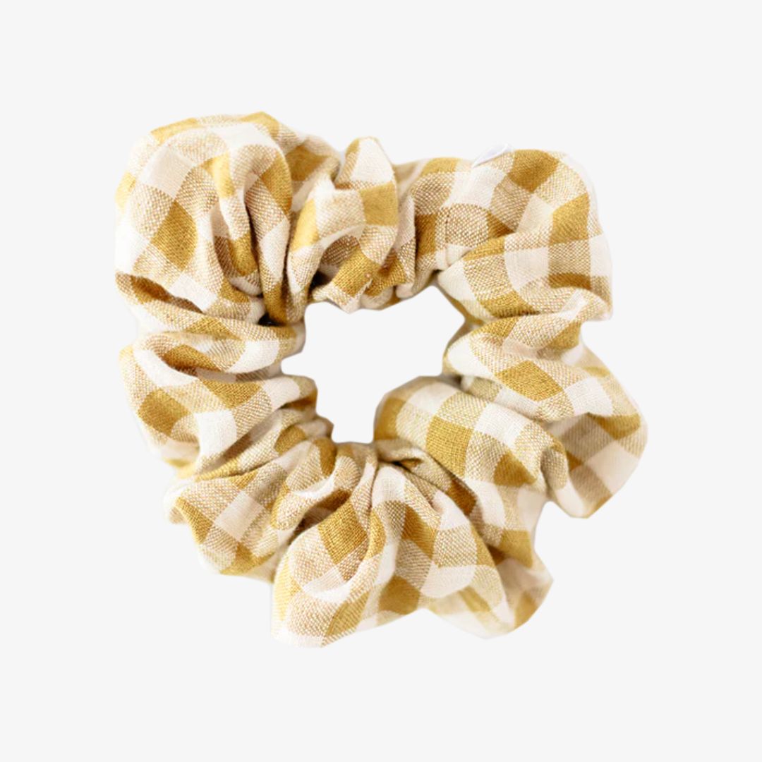 Yellow and white checkered scrunchie on a white background