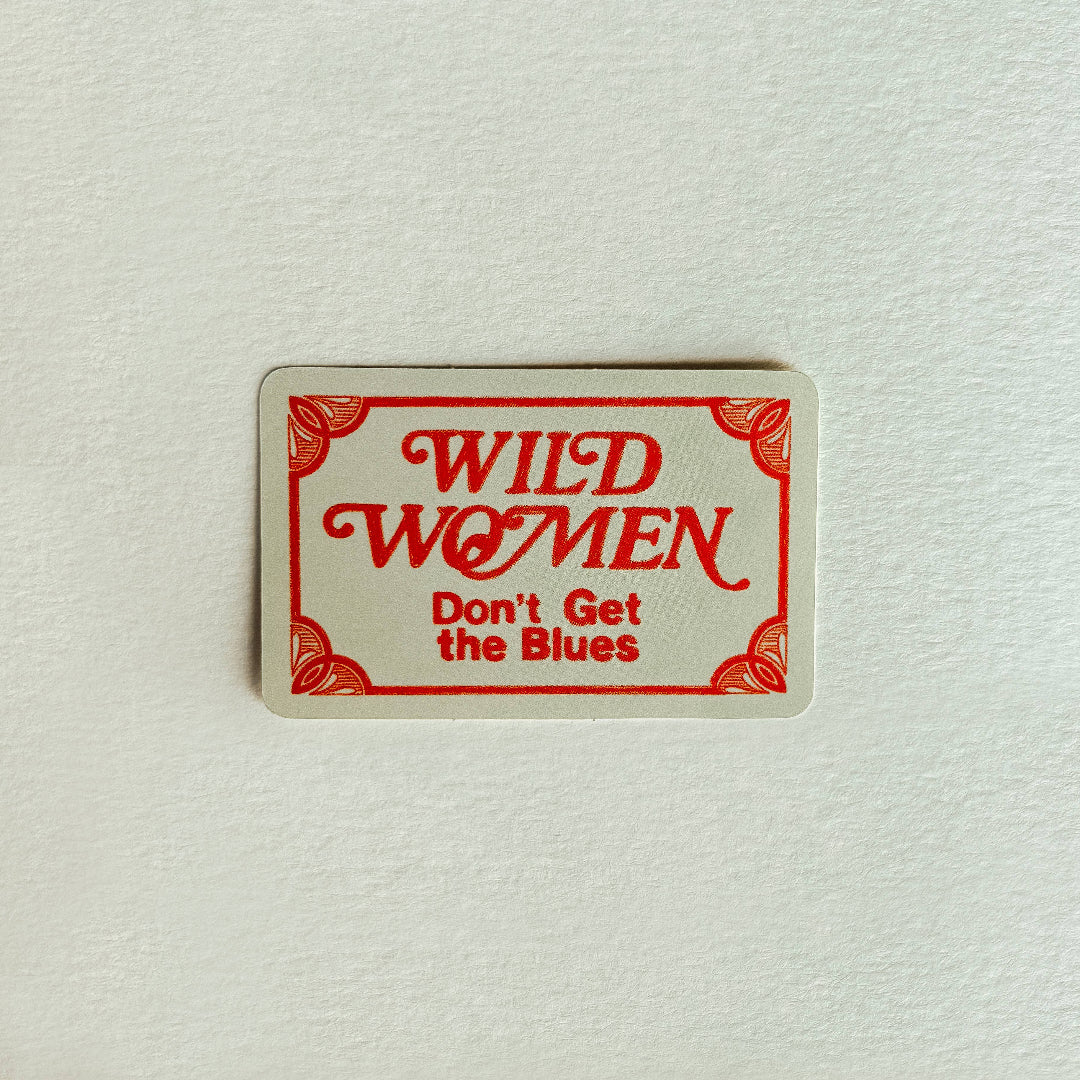 Rectangular sign with 'Wild Women Don't Get the Blues' text on a textured white background