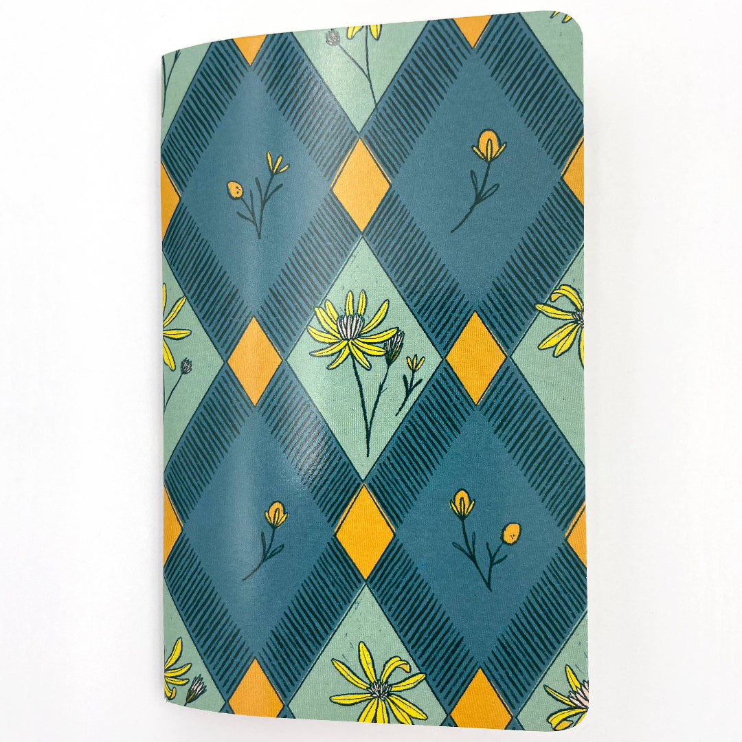 Notebook with a geometric pattern and floral design on a white background