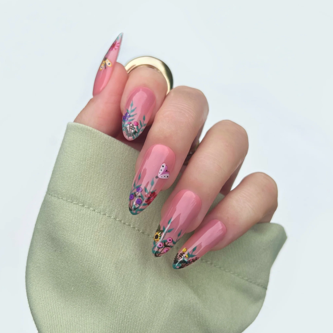 A sheet of colorful nail art stickers with various nature-themed designs. The sheet is purple and has the brand name "Deco Beauty" printed on it. There's a section titled "Wildflower" and instructions on how to apply the stickers. The stickers include designs like flowers, insects, mushrooms, and foxes.