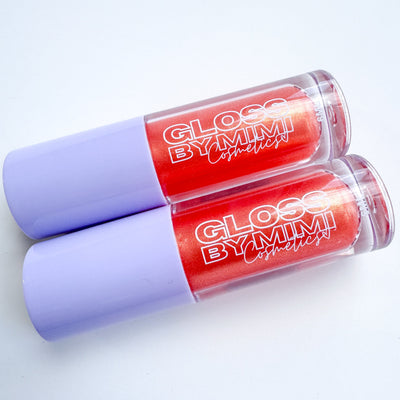 Two tubes of GLOSS by MIMI Winona Peach Lip Gloss with lavender caps and vibrant red shimmer gloss inside, perfect for showcasing a limited-edition peach-scented cosmetic.
