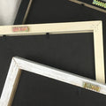 Three blackboards with different colored frames on a white fabric background