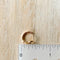 A pair of gold-plated hoop earrings shaped like hearts.