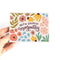 A sympathy card with a floral design. The card has a white background with colorful flowers, leaves, and the text 