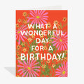 Birthday card with floral design and text on a red background
