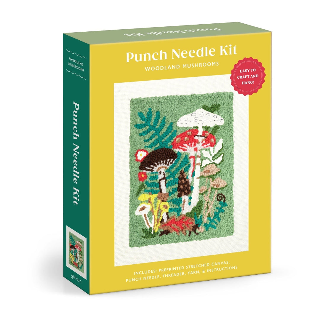 Punch Needle Kit box for woodland mushrooms, featuring a yellow front cover with a colorful mushroom patch illustration, a green spine, and a red circular badge that says 'Easy to craft and hand.'.