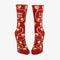 A pair of dark red women's crew socks with a winding vine pattern featuring yellow and pink tulip-shaped flowers. Text on one sock reads 