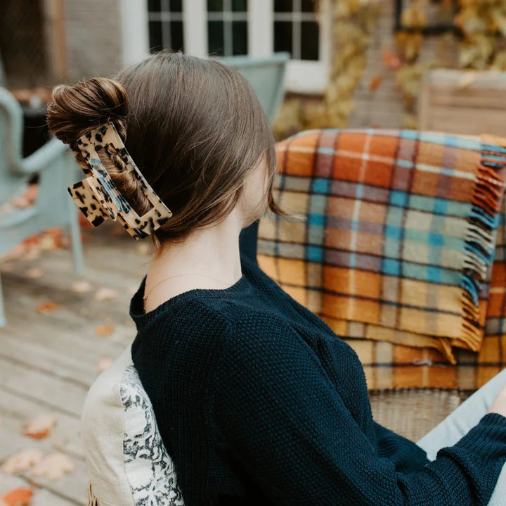A large hair claw clip in a leopard print pattern.