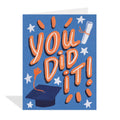 Blue greeting card featuring colourful illustrations by Erin Mac of a graduation cap with an orange tassel, a rolled diploma tied with an orange ribbon, orange bursts of light, and white stars surrounding the large, stylized orange and white text "YOU DID IT!"