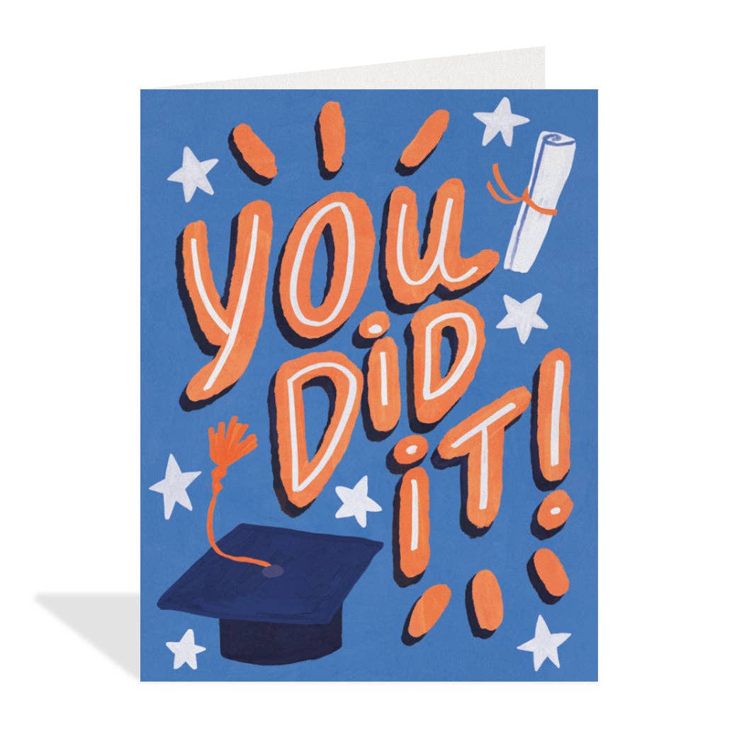 Blue greeting card featuring colourful illustrations by Erin Mac of a graduation cap with an orange tassel, a rolled diploma tied with an orange ribbon, orange bursts of light, and white stars surrounding the large, stylized orange and white text "YOU DID IT!"