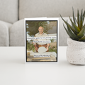 Birthday card with a humorous message on a table with a plant in the background