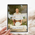 Birthday card with a photo of a man and humorous text on a textured surface