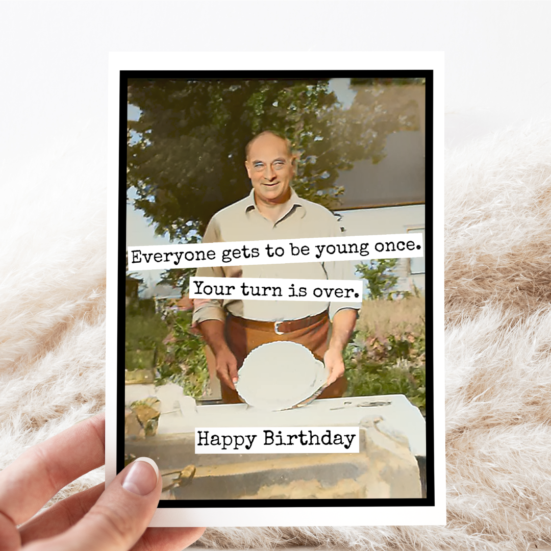 Birthday card with a photo of a man and humorous text on a textured surface
