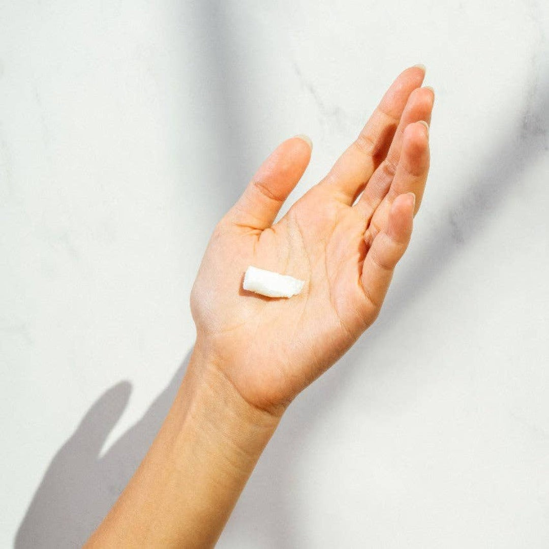 The Body Wash Concentrate, a waterless body wash concentrate in a persons hand.