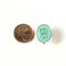 A mint green enamel pin in the shape of a speech bubble. The text 