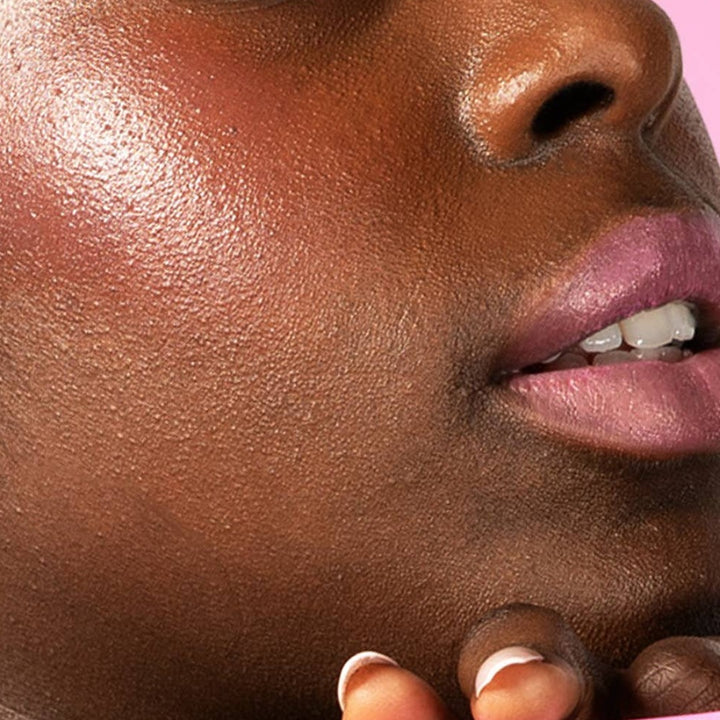 Red-dy or Not Lip & Cheek Tinted Balm, a liquid blush used on a black woman's eyes, cheeks and lips.