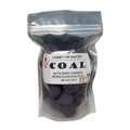 Bag of coal-shaped bath bombs with a label on a white background