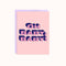 A pink greeting card with a light purple envelope. The card features the text 