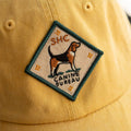 A diamond-shaped embroidered patch with a green border. It features a brown and black beagle standing facing left, with the text "SHC" above and "CANINE BUREAU" below the dog. The patch has four small stars at the corners.
