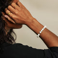 Person wearing a bracelet with a neutral background