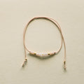 Delicate bracelet with small beads on a beige background