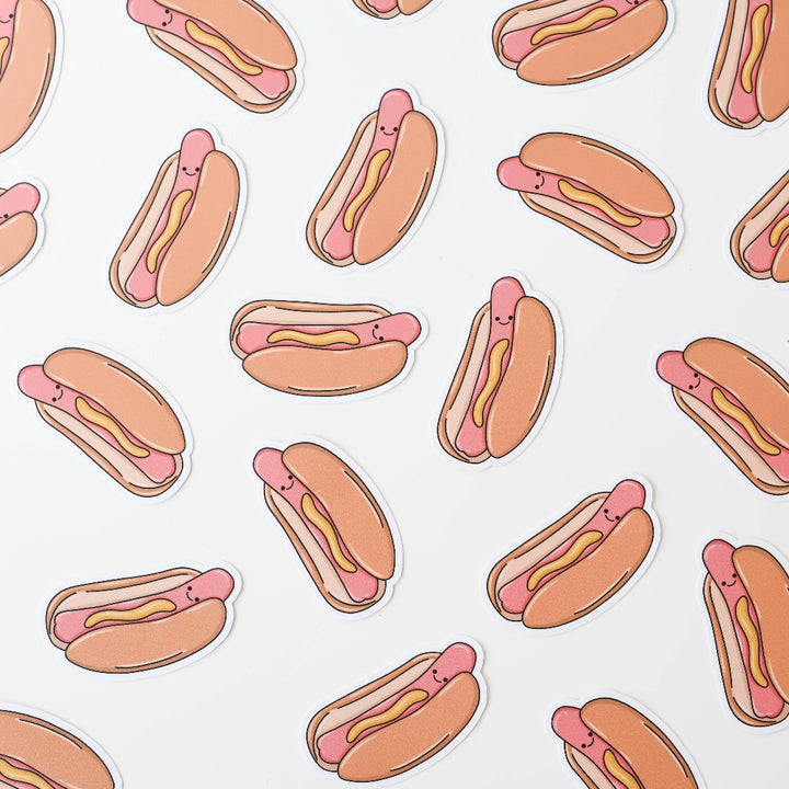 A bunch of Hot Dog Sticker, a white sticker with an image of a smiling hot dog darnished with mustard.