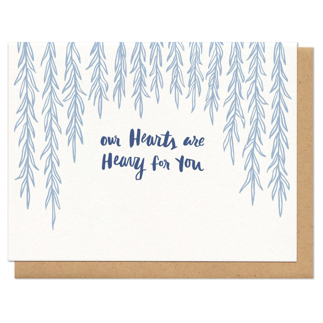 Card with blue tree illustrations and text 'our Hearts are Heavy for You' on a white background