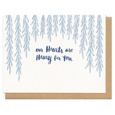 Card with blue tree illustrations and text 'our Hearts are Heavy for You' on a white background