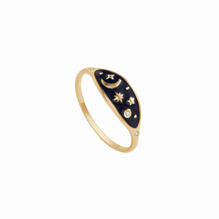 A gold ring with a black oval-shaped design featuring a crescent moon, stars, and smaller diamonds.