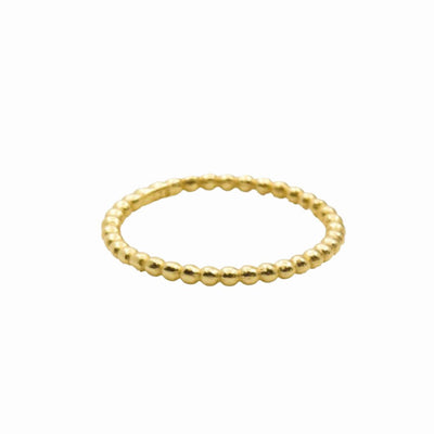 A delicate gold ring with a row of small beads.