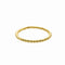 A delicate gold ring with a row of small beads.