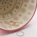 Delicate gold and silver rings with a row of small beads.