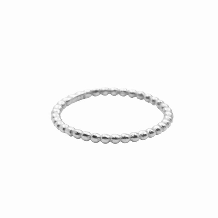 A delicate silver ring with a row of small beads.