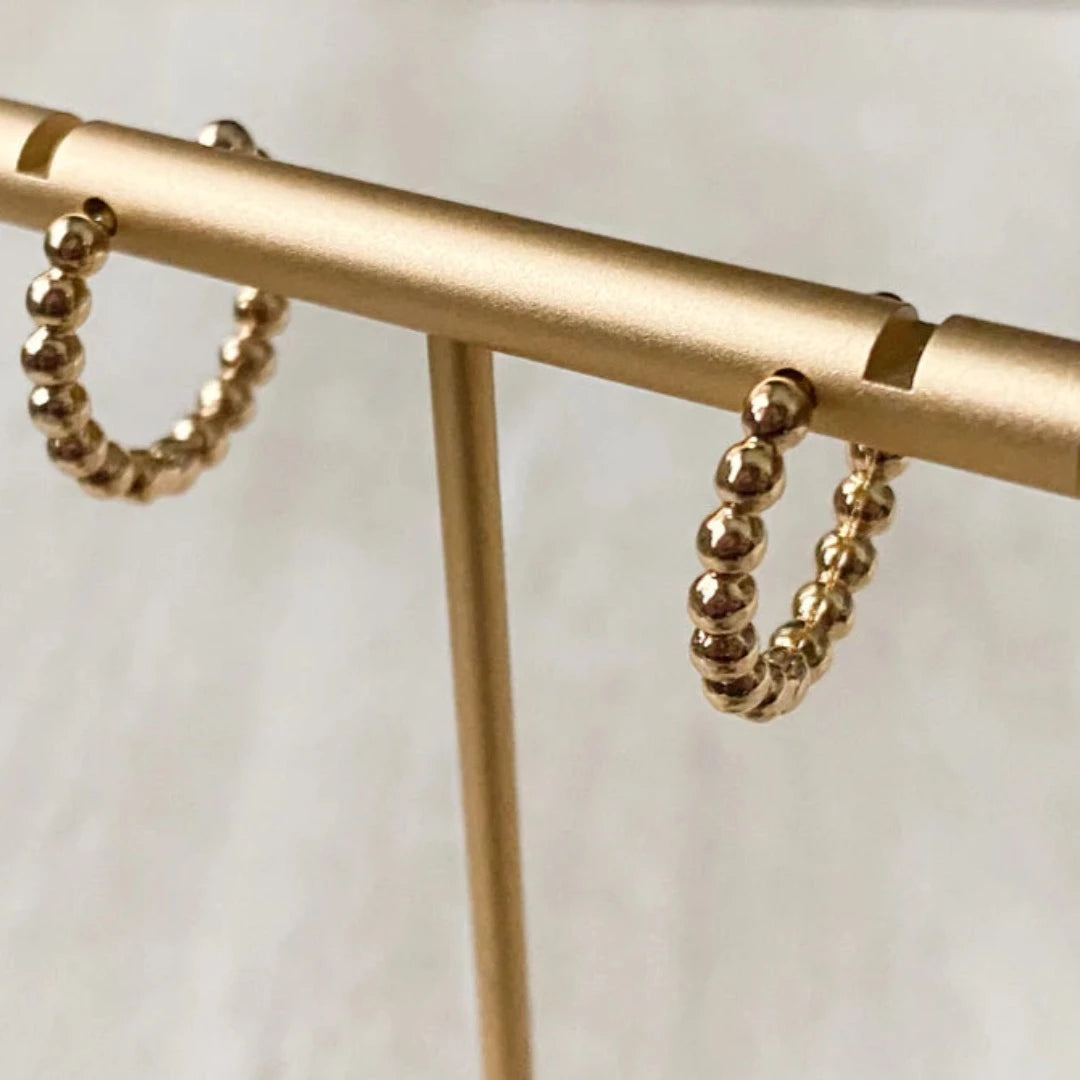 Gold Beaded Hoops. Gold hoop earrings made from gold beads connected into a circle.